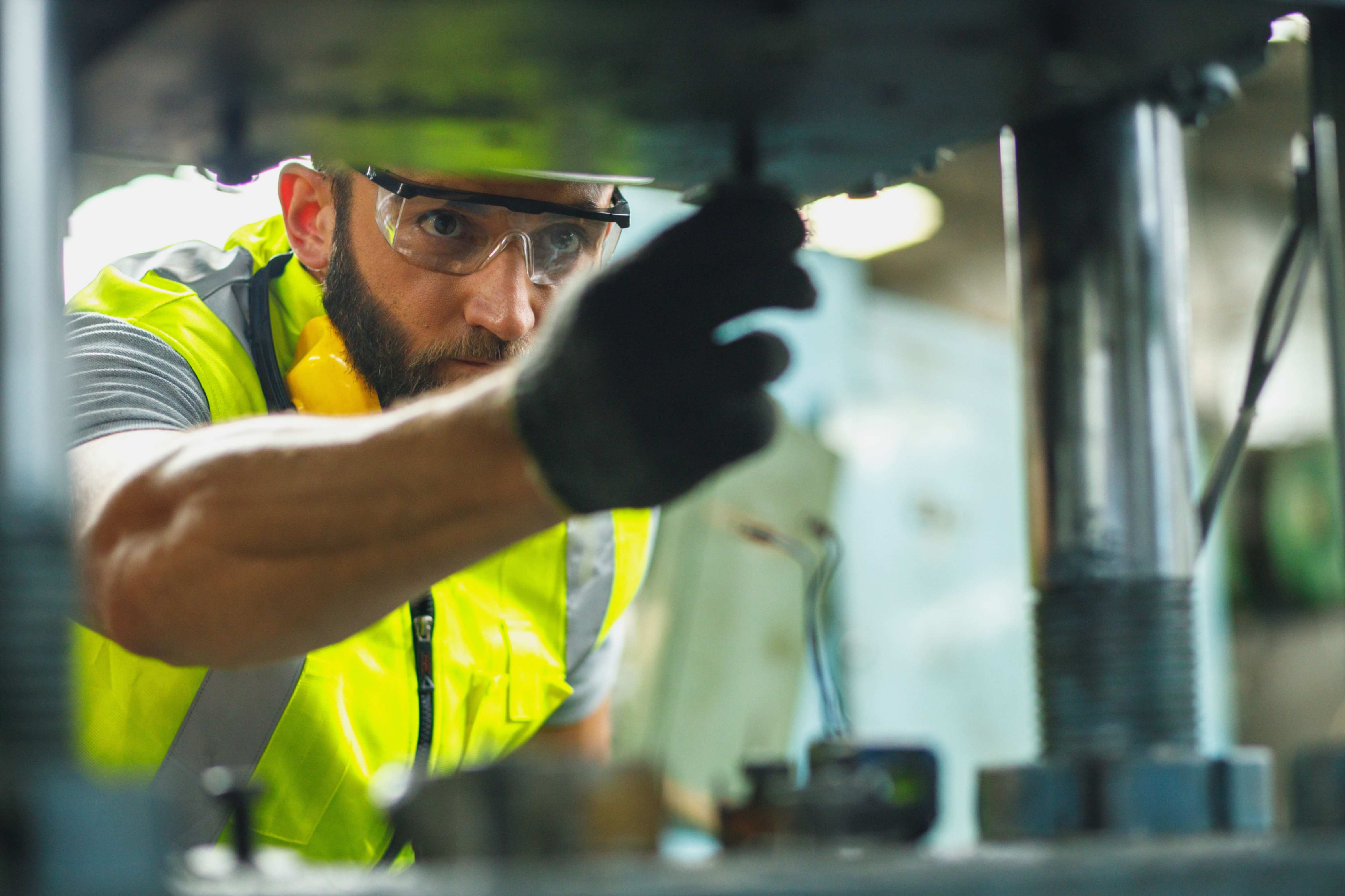 technician fine-tuning sensor settings in a laboratory with advanced equipment for asset monitoring